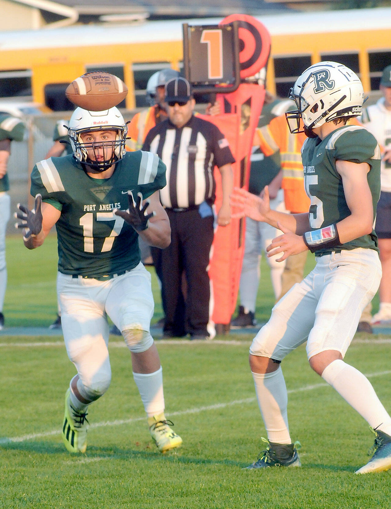 Port Angeles Jason Hawes, left, takes a backfield toss from quarterback Parker Nickerson during Friday nights game against Anacortes at Port Angeles Civic Field. (Keith Thorpe/Peninsula Daily News)