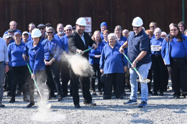 Sequim City Band members break ground on the rehearsal hall expansion project. Pictured with ceremonial shovels are, from left, band president Debbi Soderstrom, band director Tyler Benedict and Neeley Construction superintendent Eli Collier. (Michael Dashiell/Olympic Peninsula News Group)