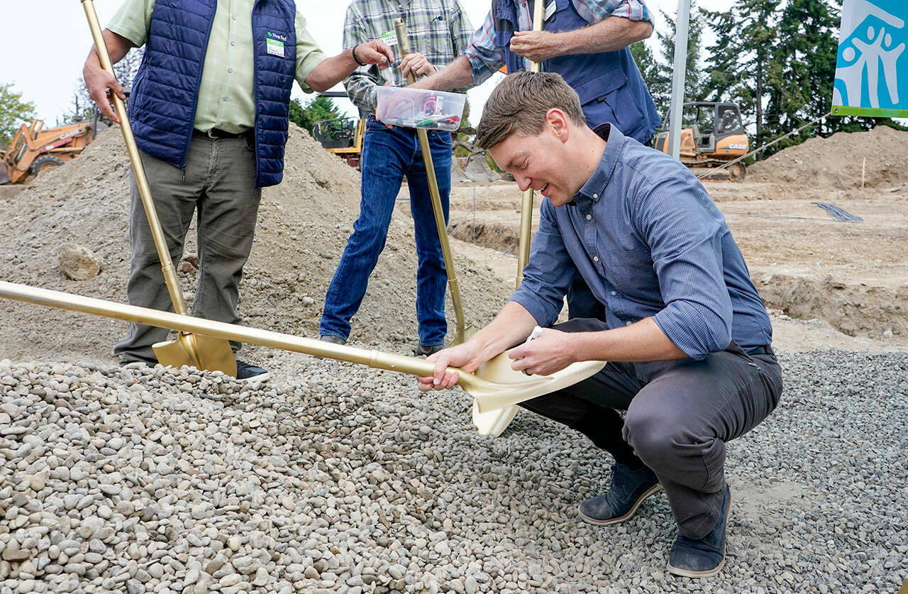 Port Townsend Mayor David Faber signs a ceremonial shovel used in the groundbreaking ceremony for six permanent, affordable housing units being constructed by East Jefferson Habitat for Humanity at 18th and Landes Streets in Port Townsend. This shovel and others will be given to each homeowner upon receiving the keys to their new home. (Steve Mullensky/for Peninsula Daily News)