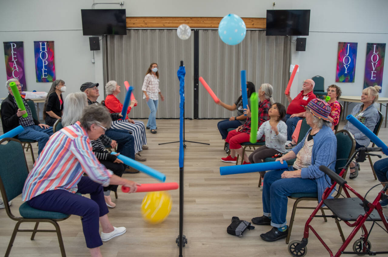 Volunteers and people living with memory loss play a variation of balloon volleyball during a Tims Place gathering at Trinity United Methodist Church in Sequim. (Emily Matthiessen/Olympic Peninsula News Group)
