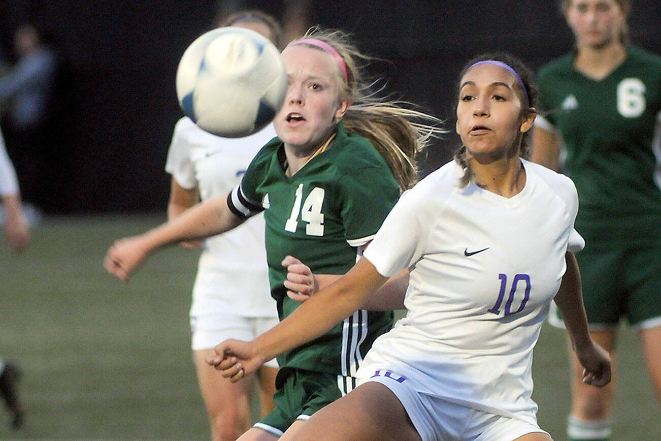 KEITH THORPE/PENINSULA DAILY NEWS
Port Angeles' Anna Petty, left, fights for a loose ball with Sequim's Jennyfer Gomez on Thursday in Port Angeles.