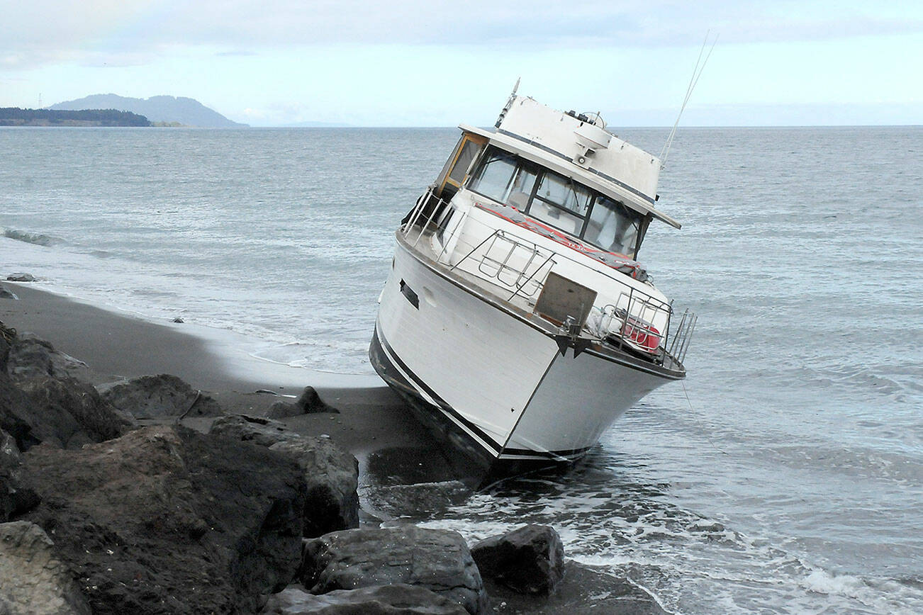 Keith Thorpe/Peninsula Daily News
A pleasure boat sits aground on the north side of Ediz Hook in Port Angeles on Friday.