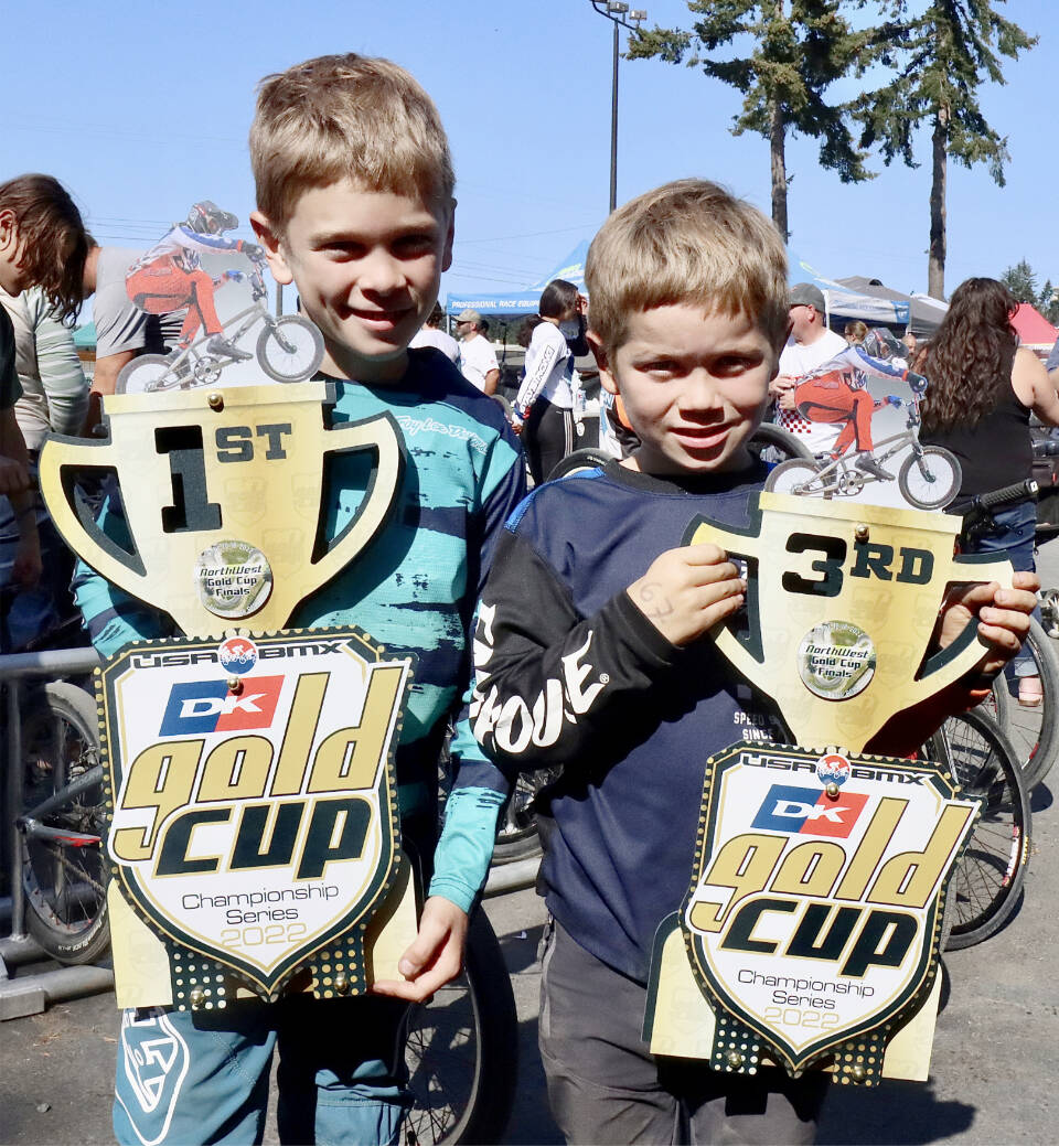 Miles Johnson of Port Angeles holds his first-place trophy in the 9 Intermediate class as his brother Maverick Johnson holds his third-place trophy in the 7 Intermediate on Sunday. (Dave Logan/for Peninsula Daily News)