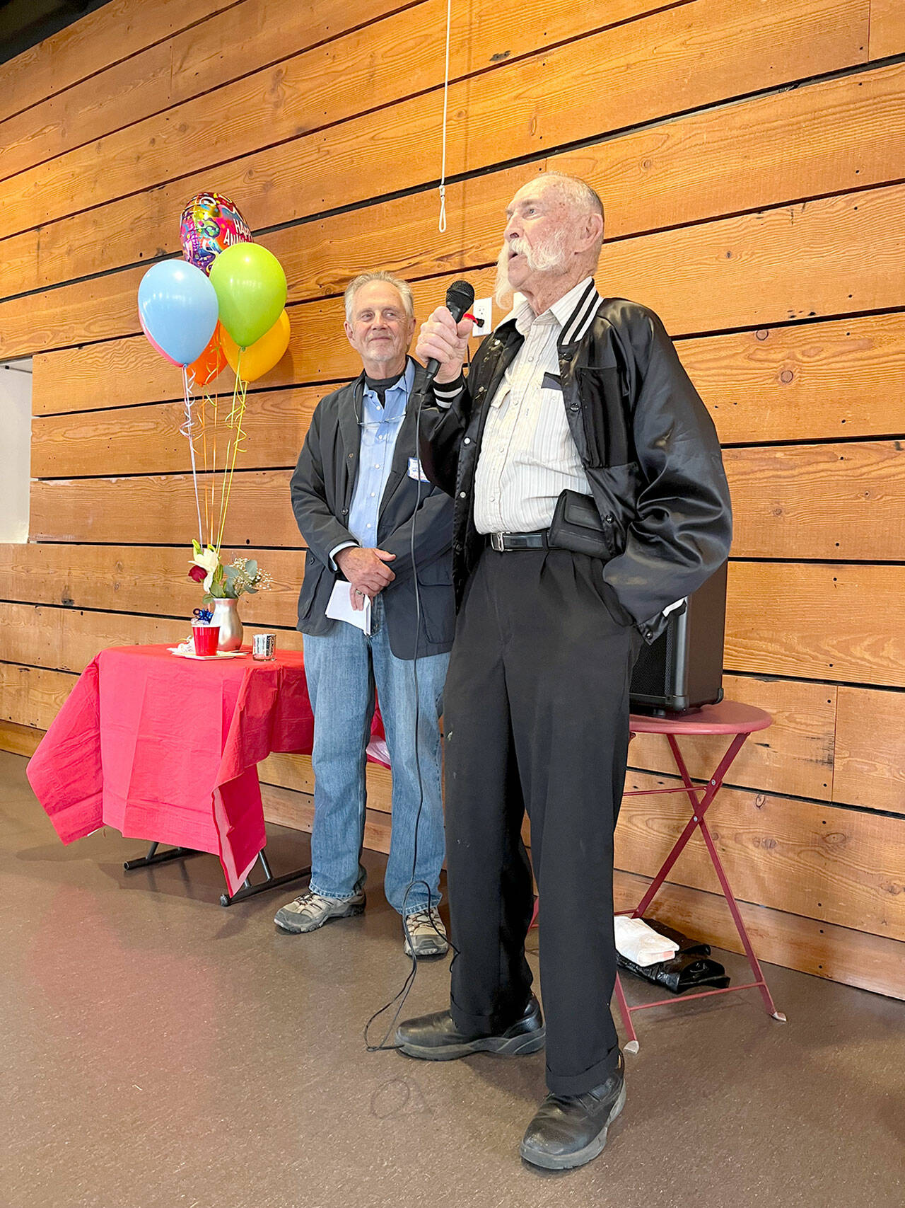 ECHHO chair David Whitney (left) listens as volunteer Roger Horner describes his experiences driving Jefferson County care receivers to their medical appointments at the non-profit organization’s 25th anniversary celebration.