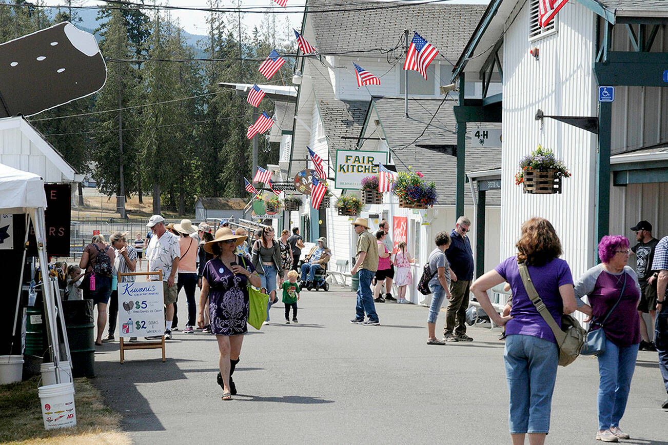 Clallam County Fair attendees stroll the midway during this year’s fair last August. (Keith Thorpe/Peninsula Daily News)