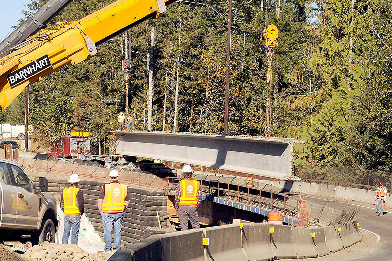 A pair of construction cranes prepare on Tuesday to hoist the second of eight 177-foot, 200,000-pound concrete girders that will support a new bridge being constructed on U.S. Highway 101 over Indian Creek southwest of Port Angeles. (Keith Thorpe/Peninsula Daily News)