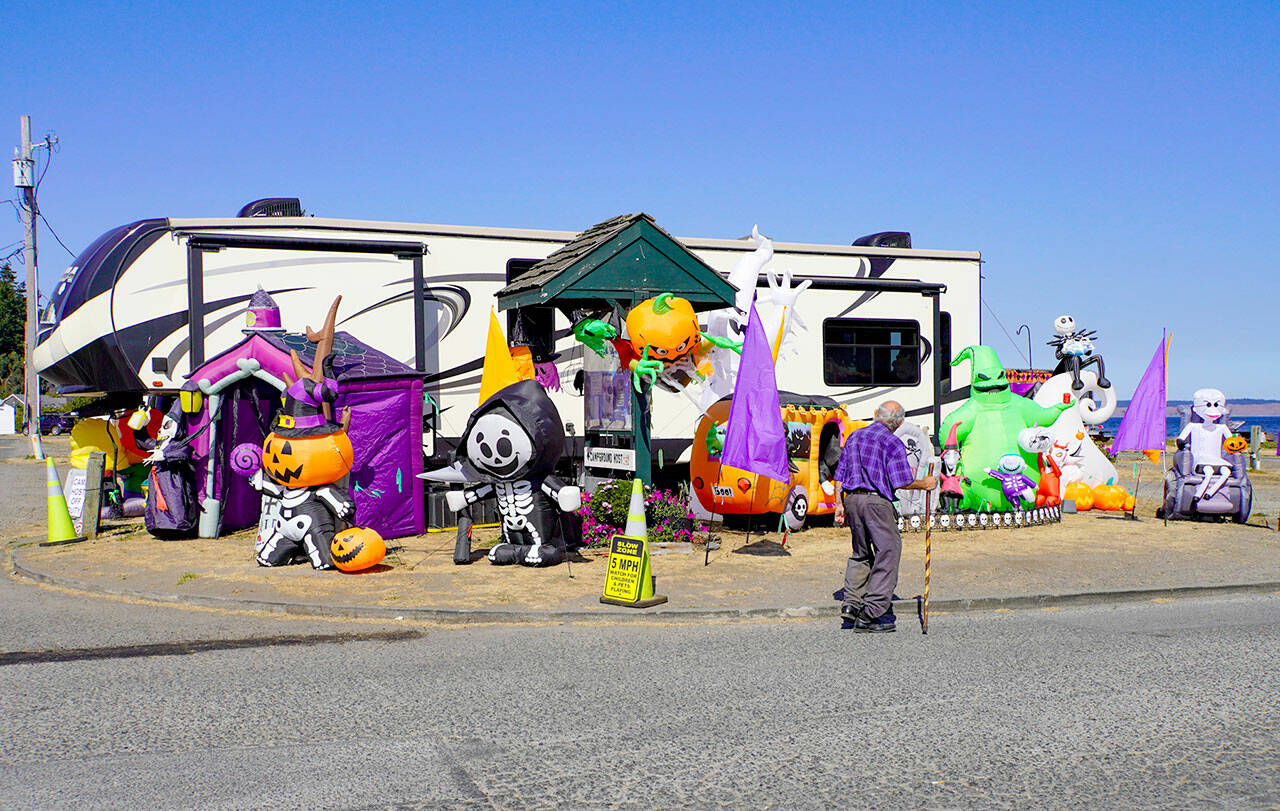 Ray Grier, a 30-year resident of Port Townsend, looks at the Halloween display set up by the park host at the entrance to the RV park at Point Hudson Marina while on his daily 2- to 3-mile walk on Tuesday afternoon. (Steve Mullensky/for Peninsula Daily News)