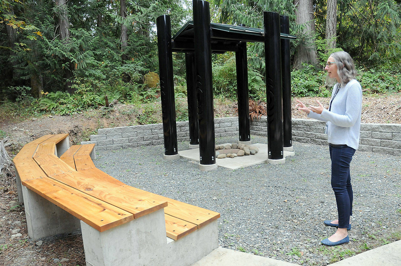 Sadie Crowe, steward for Peninsula College’ House of Learning, talks on Friday about a “learning circle” for outdoor instruction behind the Longhouse on the Port Angeles campus. (Keith Thorpe/Peninsula Daily News)