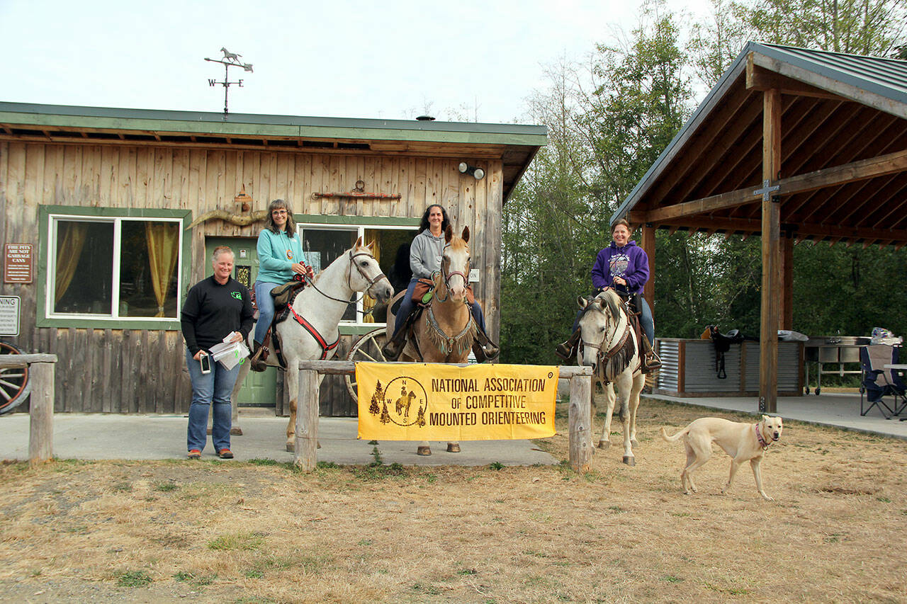 A Competitive Mounted Orienteering’s competition was held at Layton Hill Horse Camp last weekend. Organizer Wendy Brundle, left, along with one of this year’s top prize winning teams — the Free 4 Alls —in the long course competition Brianna Bell, Darcy Jaxon and Melissa Rogers. (Karen Griffiths/for Peninsula Daily News)