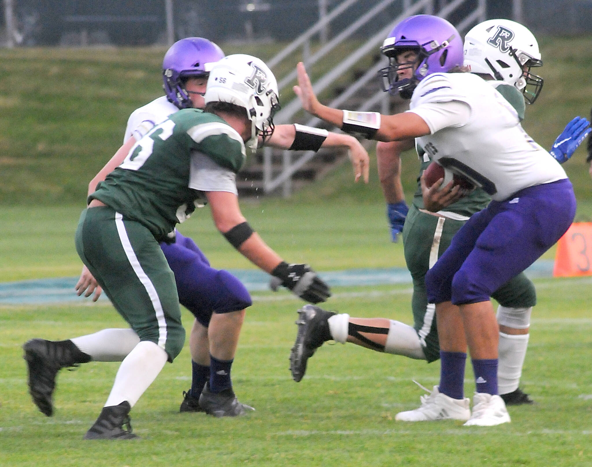 KEITH THORPE/PENINSULA DAILY NEWS
Sequim quarterback Lars Wiker, right, fends of the defense of Port Angeles' Tanner Flores on Friday night in Port Angeles.