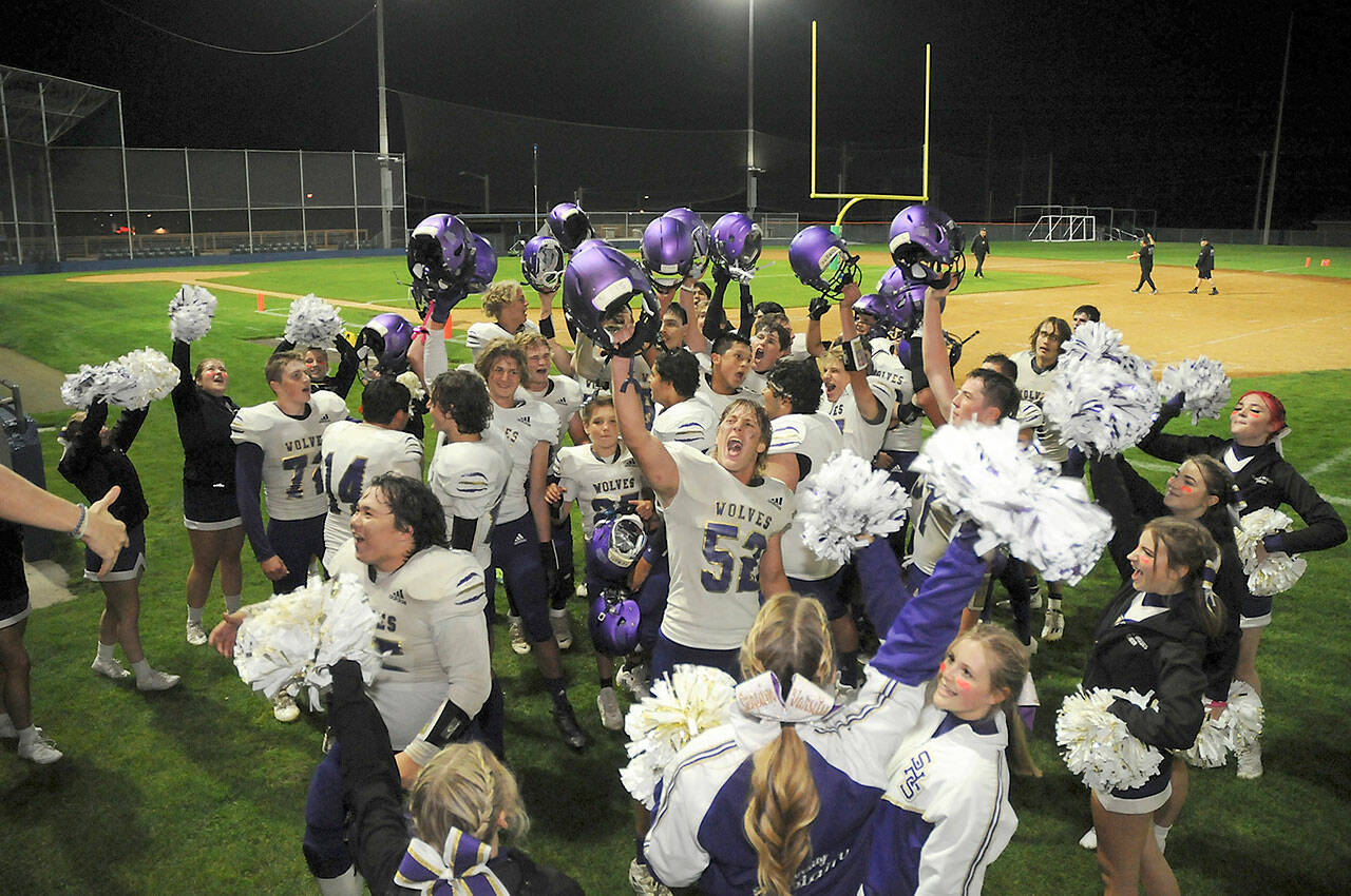 Members of the Sequim Wolves football team and cheer squad celebrate Friday night’s 36-32 come-from-behind victory over the Port Angeles Roughriders at Port Angeles Civic Field. (KEITH THORPE/PENINSULA DAILY NEWS)