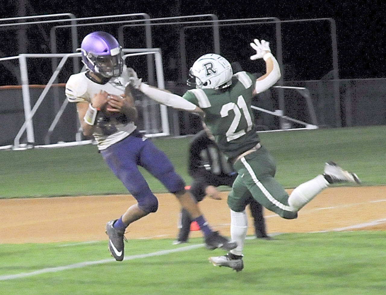 KEITH THORPE/PENINSULA DAILY NEWS Sequim’s Toppy Robideau, left, makes an end-zone reception over the defense of Port Angeles’ Tanner Jacobsen in the closing seconds of the fourth quarter to put the Wolves over the Roughriders on Friday night in Port Angeles.