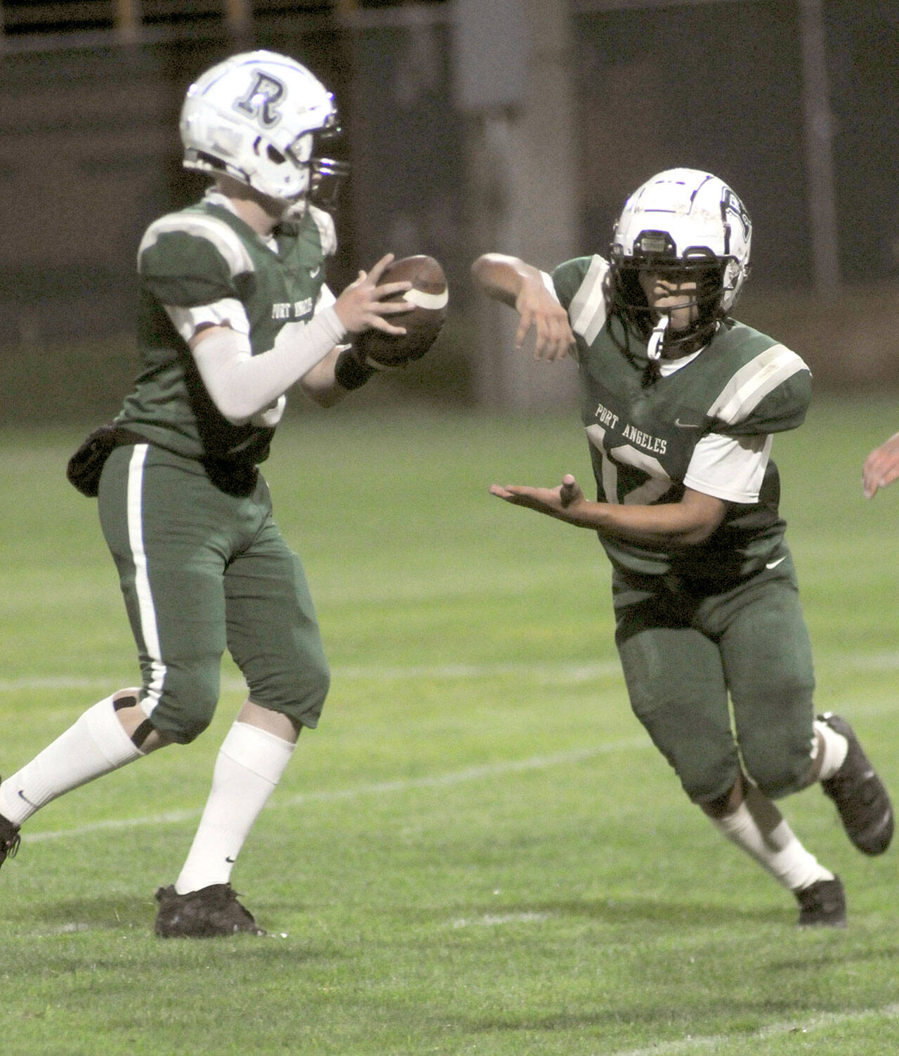 Port Angeles reserve quarterback Brandt Perry fakes a handoff to teammate Kason Albaugh before competing a touchdown pass to Blake Sohlberg in the fourth quarter Friday in Port Angeles. (KEITH THORPE/PENINSULA DAILY NEWS)