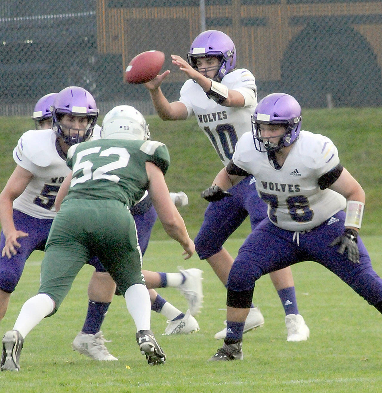KEITH THORPE/PENINSULA DAILY NEWS
Sequim quarterback Lars Weiker receives the snap as linemen Ayden Holland, left, and Nehemiah Guzman defend against Port Angeles' Thomas Arand on Friday.