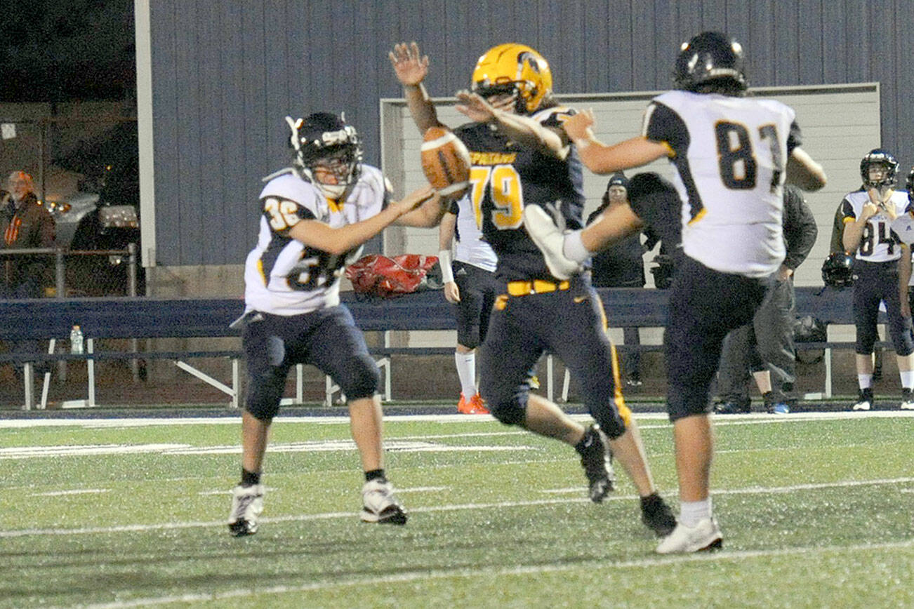 Spartan Casimir Pullen (79) blocked this Ilwaco punt by Josh Wall (81).  It was a tuff defense displayed all evening by Forks Friday night on the Spartan turf.  Photo by Lonnie Archibald.