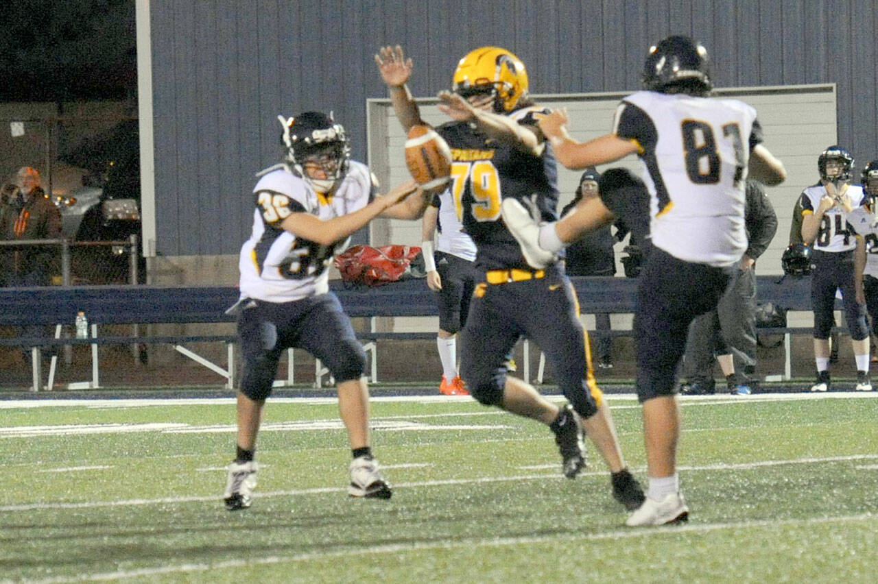 Forks’ Casimir Pullen (79) blocked this Ilwaco punt by Josh Wall (81) at Spartan Field on Friday night. It was a tough defense displayed all evening by Forks as the Spartans allowed just six points. (Lonnie Archibald/for Peninsula Daily News)