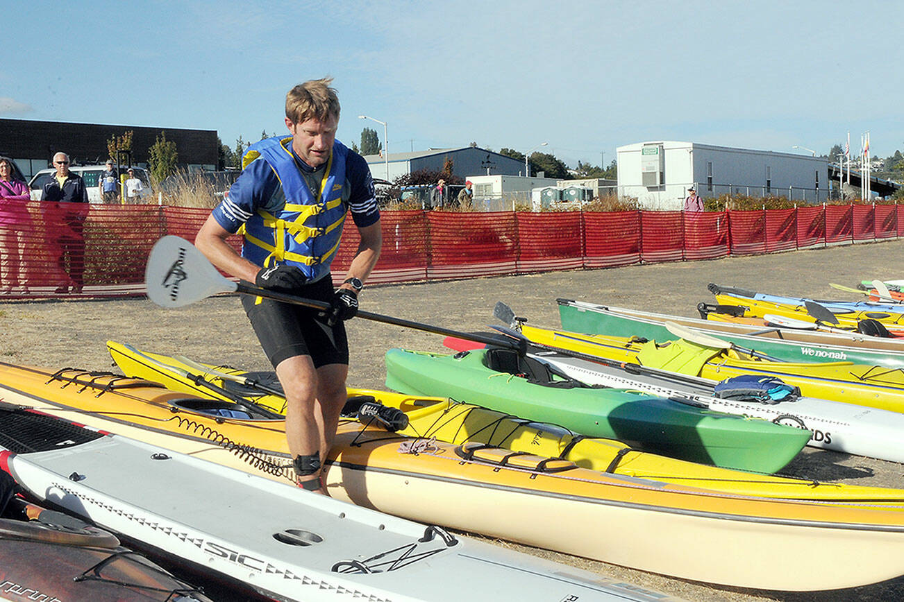 KEITH THORPE/PENINSULA DAILY NEWS
Ian Mackie of Gig Harbor prepares to launch his kayak from Pebble Beach as an iron man competitor during Saturday's Big Hurt in Port Angeles.
