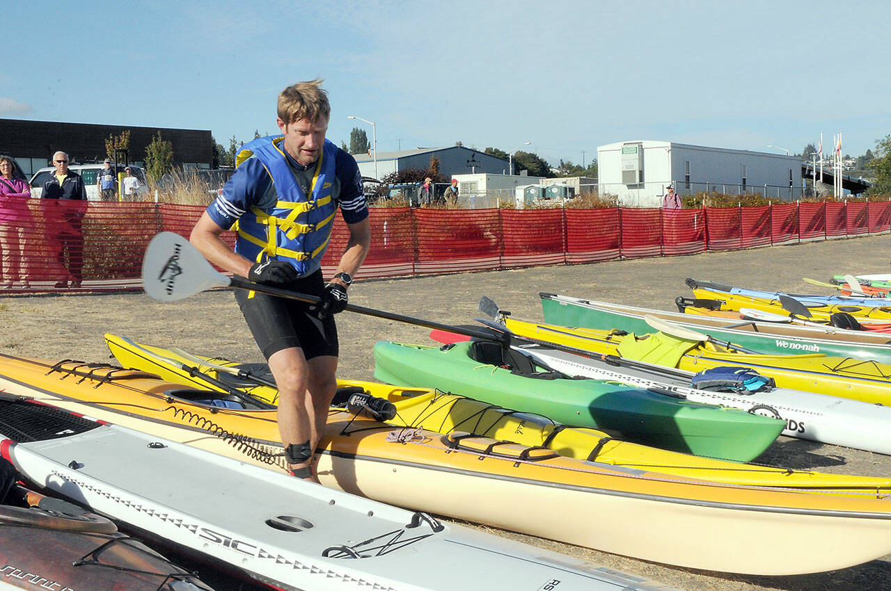Ian Mackie of Gig Harbor prepares to launch his kayak from Pebble Beach as an ironman competitor during Saturday’s Big Hurt in Port Angeles. Mackie finished second overall. (Keith Thorpe/Peninsula Daily News)