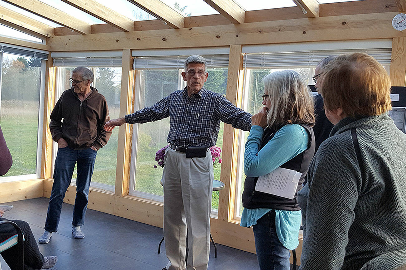 Submitted photo 

David Large leads a small tour in November of his home that produces more energy than it uses. He hosts an open house Saturday.