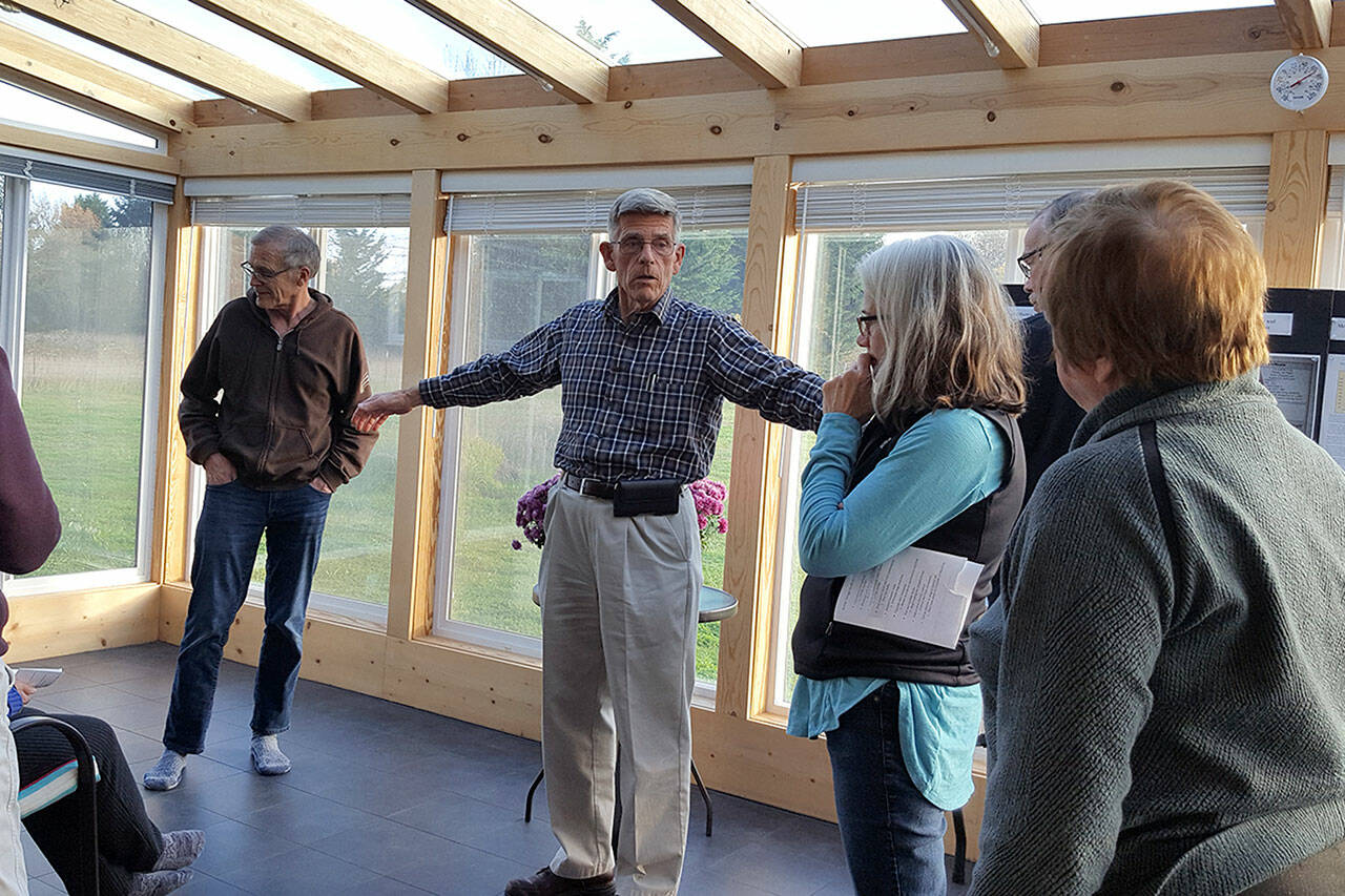 David Large leads a small tour in November of his home that produces more energy than it uses. He will host an open house Saturday. (Submitted photo)