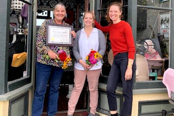 From left to right, Boat School Executive Director Betsy Davis and Ajax Café owner Kristan McCary celebrate the recognition of the Galster House, home of the Ajax Café, with this year’s Mary P. Johnson Award for historic preservation presented by the Jefferson County Historical Society and its executive director, Shelly Leavens.