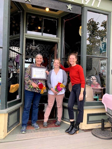 From left to right, Boat School Executive Director Betsy Davis and Ajax Café owner Kristan McCary celebrate the recognition of the Galster House, home of the Ajax Café, with this year’s Mary P. Johnson Award for historic preservation presented by the Jefferson County Historical Society and its executive director, Shelly Leavens.