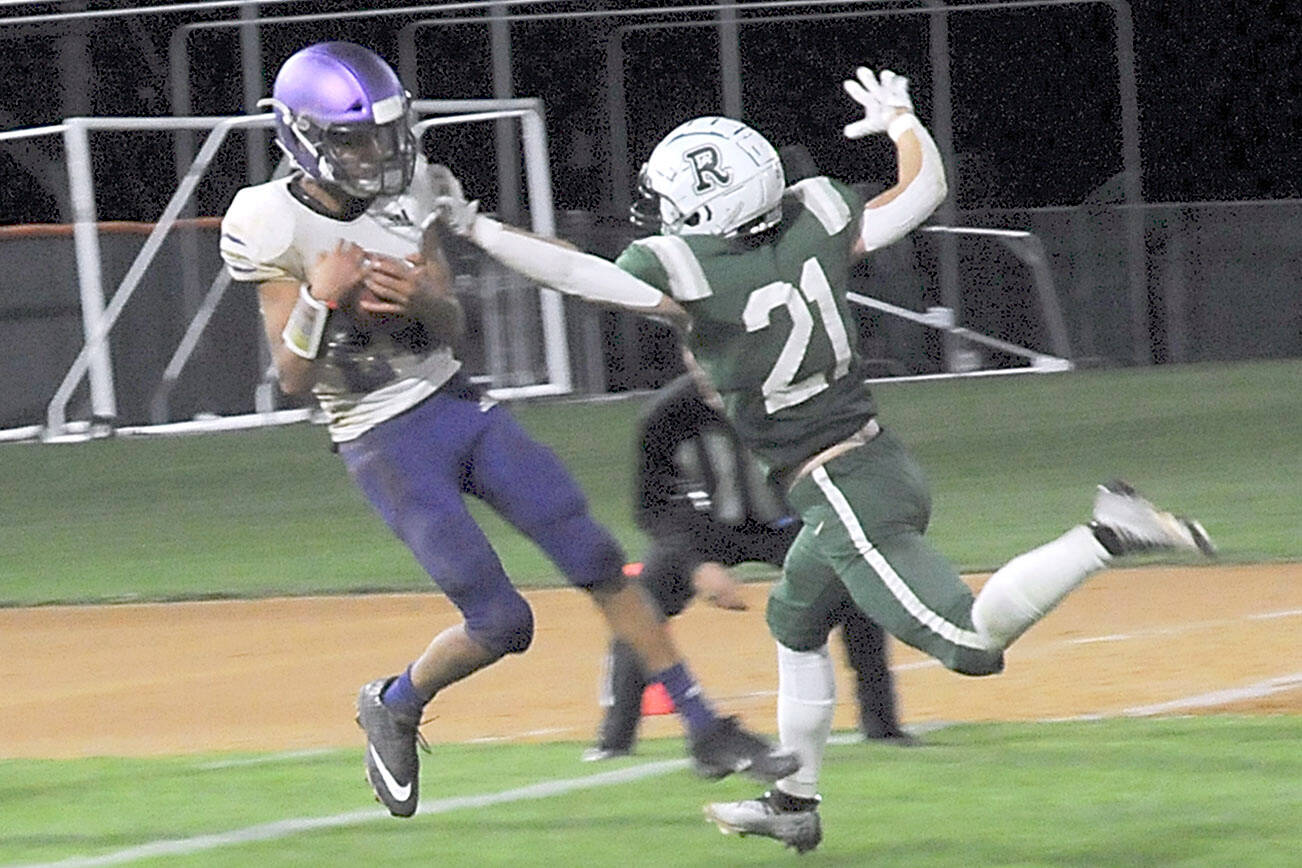 KEITH THORPE/PENINSULA DAILY NEWS
Sequim's Toppy Robideau, left, makes an end-zone reception over the defense of Port Angeles' Tanner Jacobsen in the closing seconds of the fourth quarter to put the Wolves over the Roughriders on Friday night in Port Angeles.