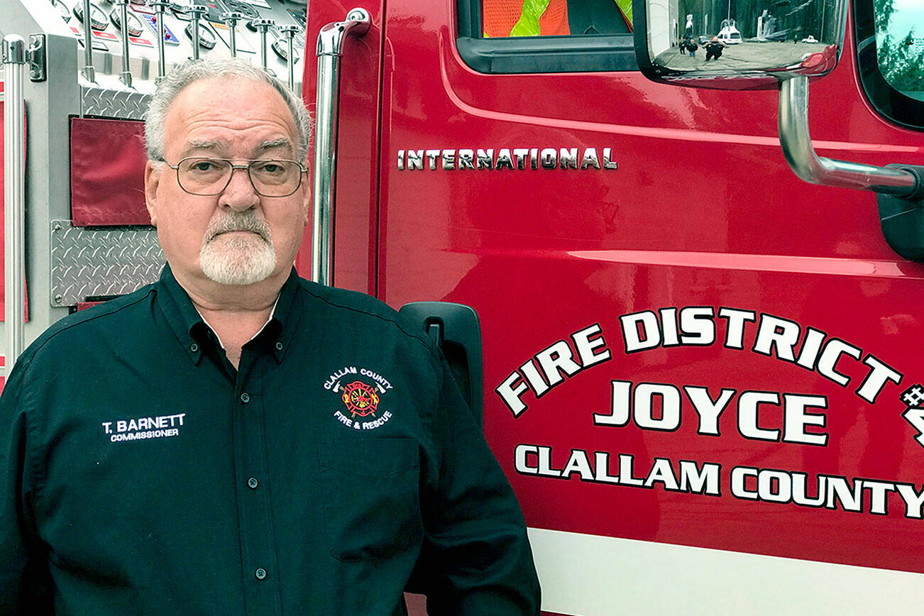 Clallam County Fire District No. 4)  
The late Terry Wayne Barnett, who was a Joyce Fire District Commissioner and chair of the building committee, is pictured standing in front of one of the fire trucks he wanted to be housed in the planned apparatus barn in Joyce.