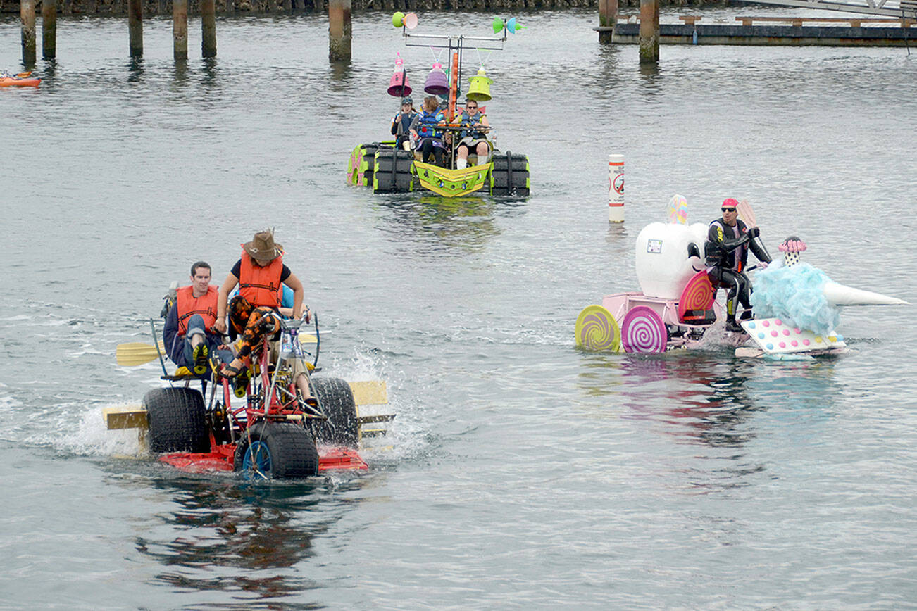 Despite the rain and cooler temperatures teams were in high spirits as they tackled the water course on day at an earlier Kinetic Skulpture Race in Port Townsend. (Peninsula Daily News)