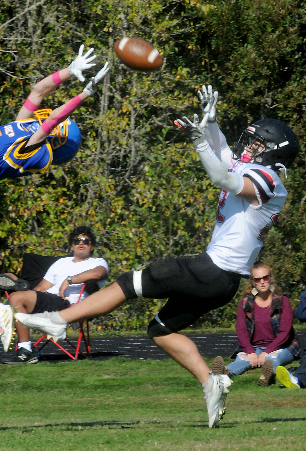 Neah Bay’s Adam Ellis, right, attempts to catch a pass over the head of a Crescent player on Saturday in Joyce. (Keith Thorpe/Peninsula Daily News)