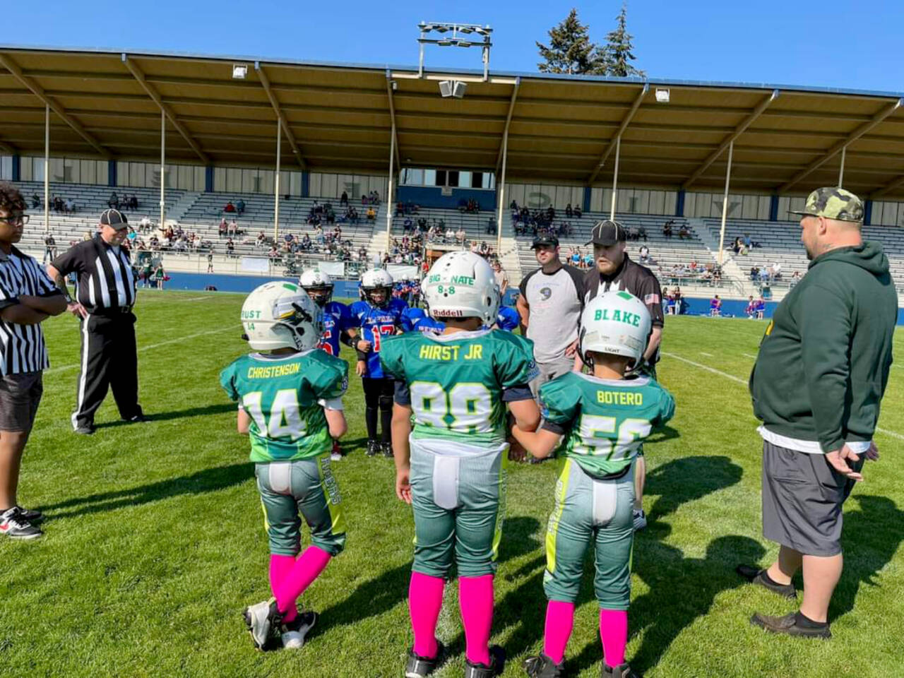 From left, Trust Christianson, Nate Hirst Jr. and Blake Botero wait on the sidelines during the Future Riders Green C team's 44-14 win Saturday at Civic Field. (Courtesy photo)