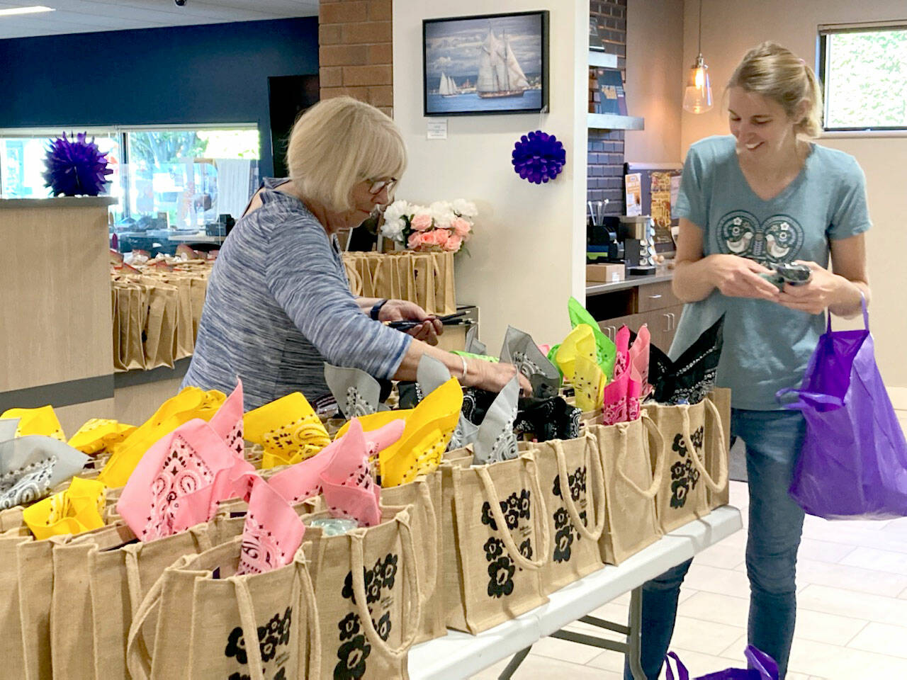 Port Townsend Main Street Program Promotion Committee members Sue Arthur, left, and Jennifer Wake help make 500 goodie bags filled with donations from local merchants and sponsors to be sold at Thursdays Girls Night Out headquarters at Vintage by Port Townsend Vineyards, 725 Water St., starting at 11 a.m. Proceeds from the goodie bag sales support the nonprofit Main Street Program and the Jefferson Healthcare Foundations fund to help people in need receive breast and cervical cancer screenings and other services. The event will feature a day and night of shopping at 38 businesses with many open later than usual. The theme is the 1960s You Go Go Girl! The wrap party will be at 6 p.m. at Vintage by Port Townsend Vineyards. For more, see ptmainstreet.org.