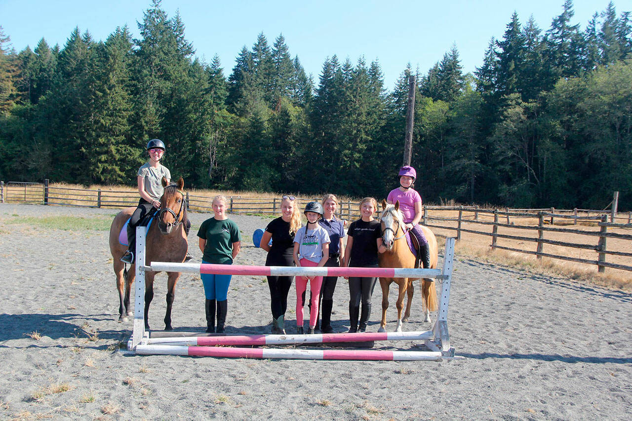 Ranahan Pony Club members Asha Swanberg, 13, left, Elise Sirguy, 12, Libby Swanberg, 15, and Danica Pacilel, 13, with sisters Sierra, 17, Marissa, 15, and Eliza Steffen, 9, gather for a lesson at Serenity Farms, located off Blue Mountain Road east of Port Angeles. (Karen Griffiths/For Peninsula Daily News)