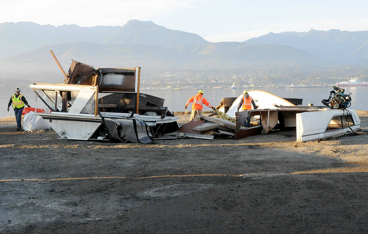 Remains of the broken pleasure craft Eudora await disposal at a staging area on Ediz Hook in Port Angeles on Wednesday morning. (Keith Thorpe/Peninsula Daily News)