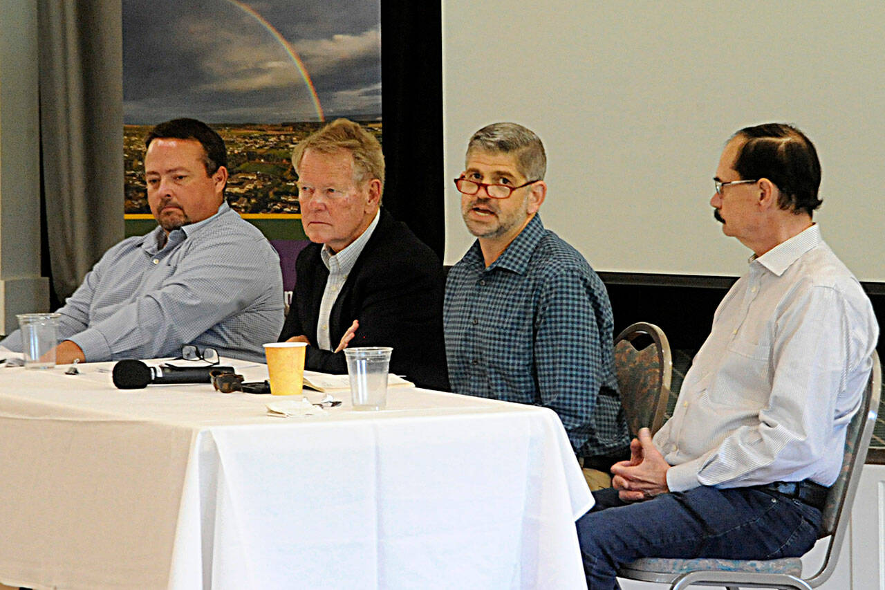 Clallam County commissioners, second from left, Randy Johnson, Mark Ozias, and Bill Peach, along with Mark Lane, Clallam County chief financial officer, on left, speak during the Sequim-Dungeness Valley Chamber of Commerce luncheon. (Matthew Nash/Olympic Peninsula News Group)