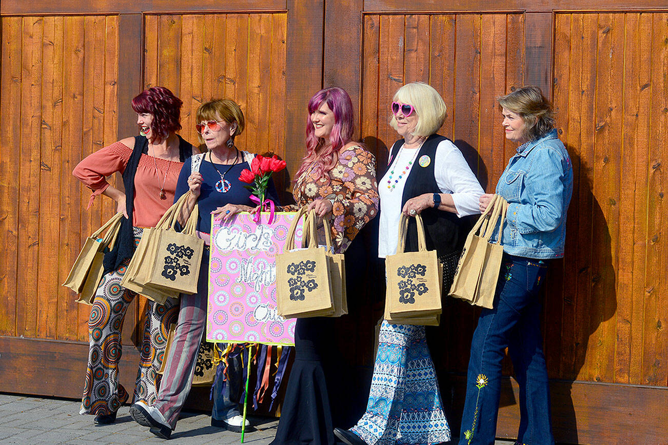 Preparing to celebrate Girls’ Night Out in downtown Port Townsend on Thursday afternoon are, from left, Holly Erickson, Lorilee Houston, Eryn Smith, Sue Arthur and Mari Mullen. After a hiatus, the Main Street Program-hosted annual event returned to distribute goodie bags, encourage women to shop local and raise funds for the Jefferson Healthcare Foundation. The foundation helps provide free breast/cervical cancer screenings for women in need. (Diane Urbani de la Paz/For Peninsula Daily News)