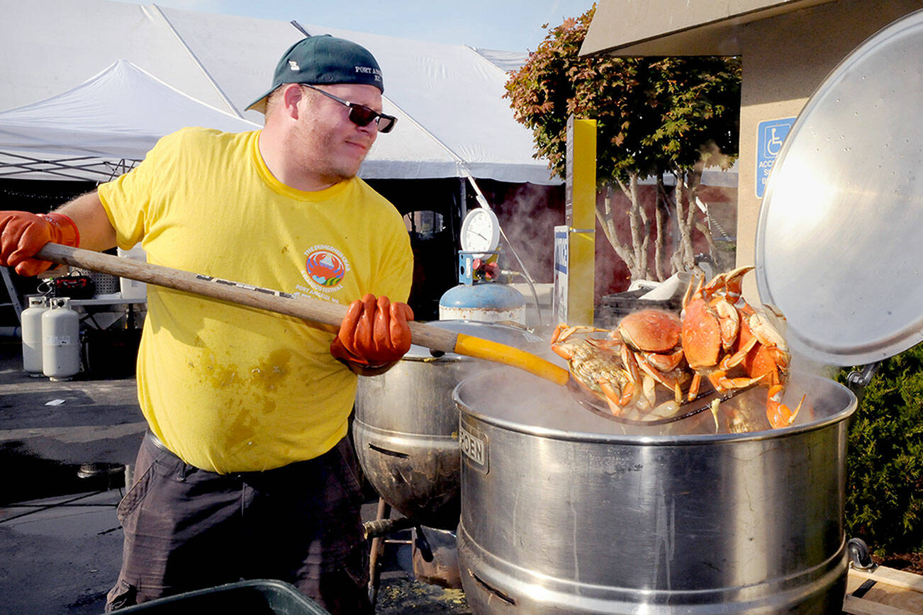 Crab crew member Jacob Brown of Port Angeles pulls cooked crab from a boiler on Thursday in preparation for the opening of the Dungeness Crab and Seafood Festival on the Port Angeles waterfront. The three-day festival begins today and runs through Sunday. For more information, see Page A6. (Keith Thorpe/Peninsula Daily News)