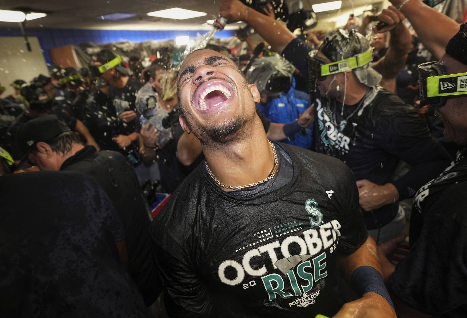 Seattle Mariners’ Julio Rodriguez (44) reacts after being sprayed with champagne following the team’s win over the Toronto Blue Jays in Game 2 of the AL wild-card playoff series Saturday in Toronto. (Nathan Denette/The Canadian Press via AP)
