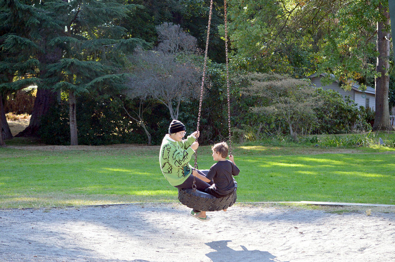 Fiona Krienke, 19, and her brother Hawk, 6, take a spin on the tire swing at Chetzemoka Park in Port Townsend. The 118-year-old city park is named after Chief Chetzemoka, the 19th century SKlallam leader. (Diane Urbani de la Paz/Peninsula Daily News)