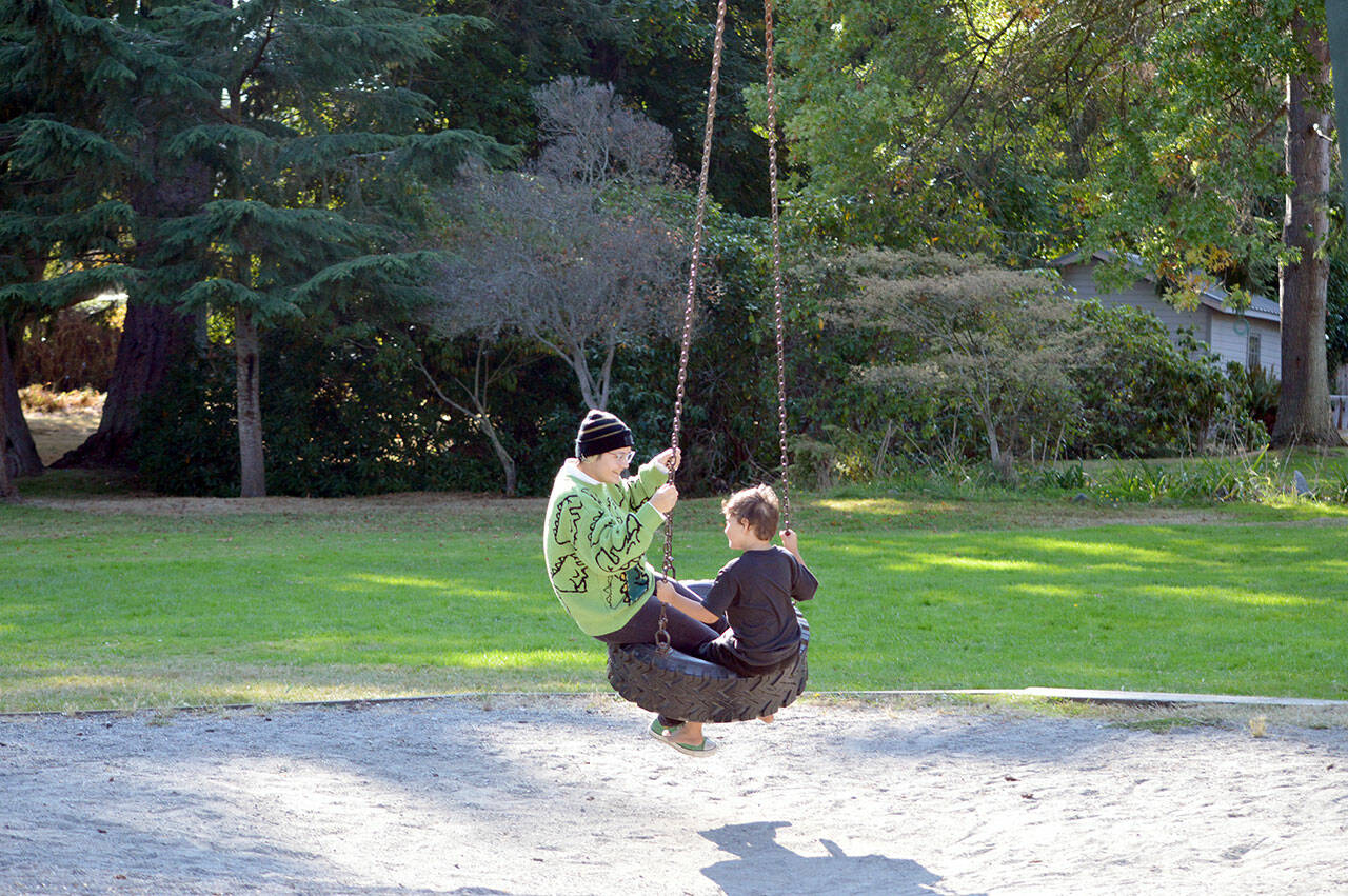 Fiona Krienke, 19, and her brother Hawk, 6, take a spin on the tire swing at Chetzemoka Park in Port Townsend. The 118-year-old city park is named after Chief Chetzemoka, the 19th century S’Klallam leader. (Diane Urbani de la Paz/Peninsula Daily News)