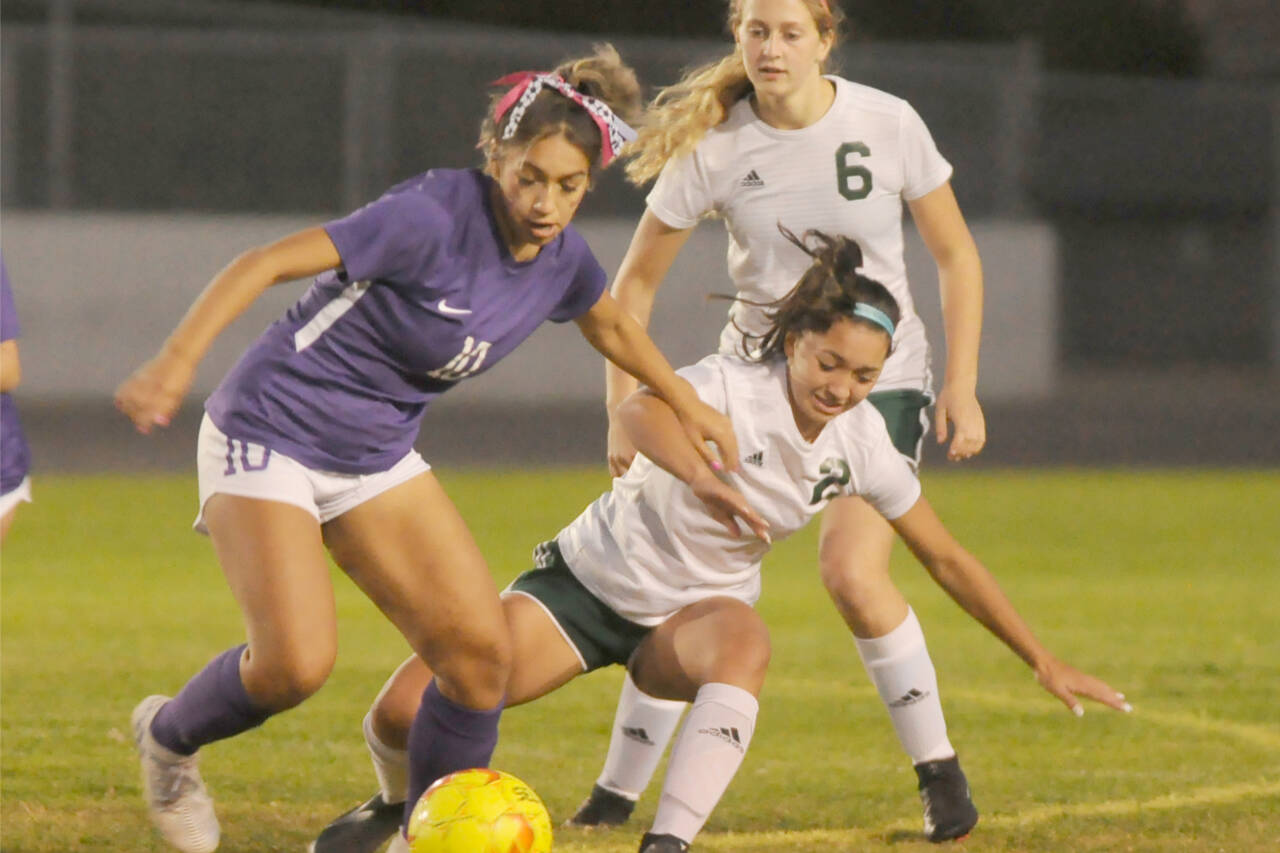 Sequim's Jennyfer Gomez (10) battles for the ball along with Port Angeles' Piper Williams (2) and Becca Manson (6) in Sequim on Tuesday night. (Michael Dashiell/Olympic Peninsula News Group)