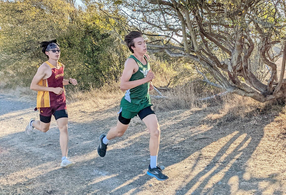 Port Angeles' Max Baeder runs ahead of a Kingston competitor during Wednesday's Olympic League meet at the Dungeness Recreation Area near Sequim.
