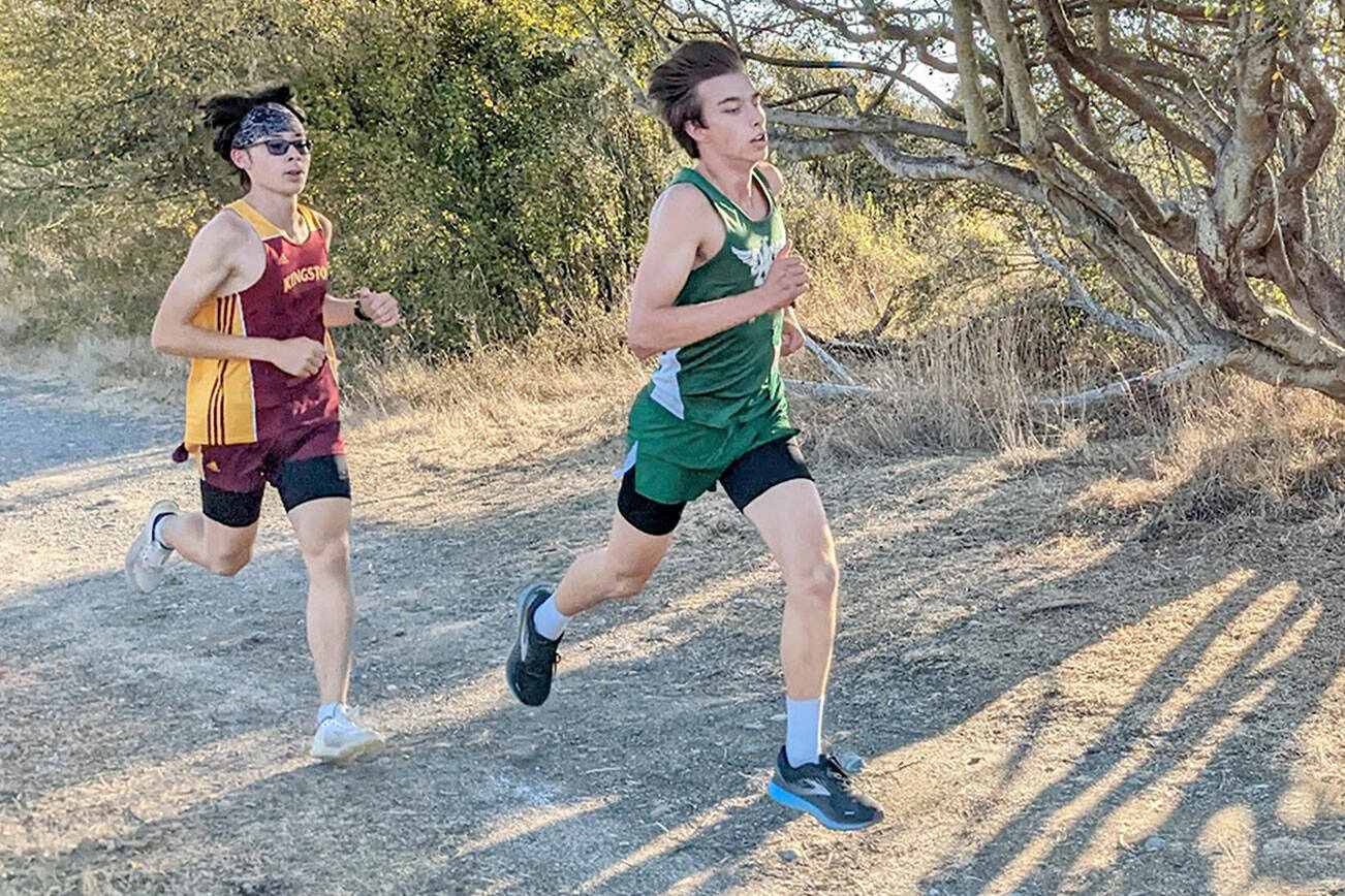 Port Angeles' Max Baeder runs ahead of a Kingston competitor during Wednesday's Olympic League meet at the Dungeness Recreation Area near Sequim.