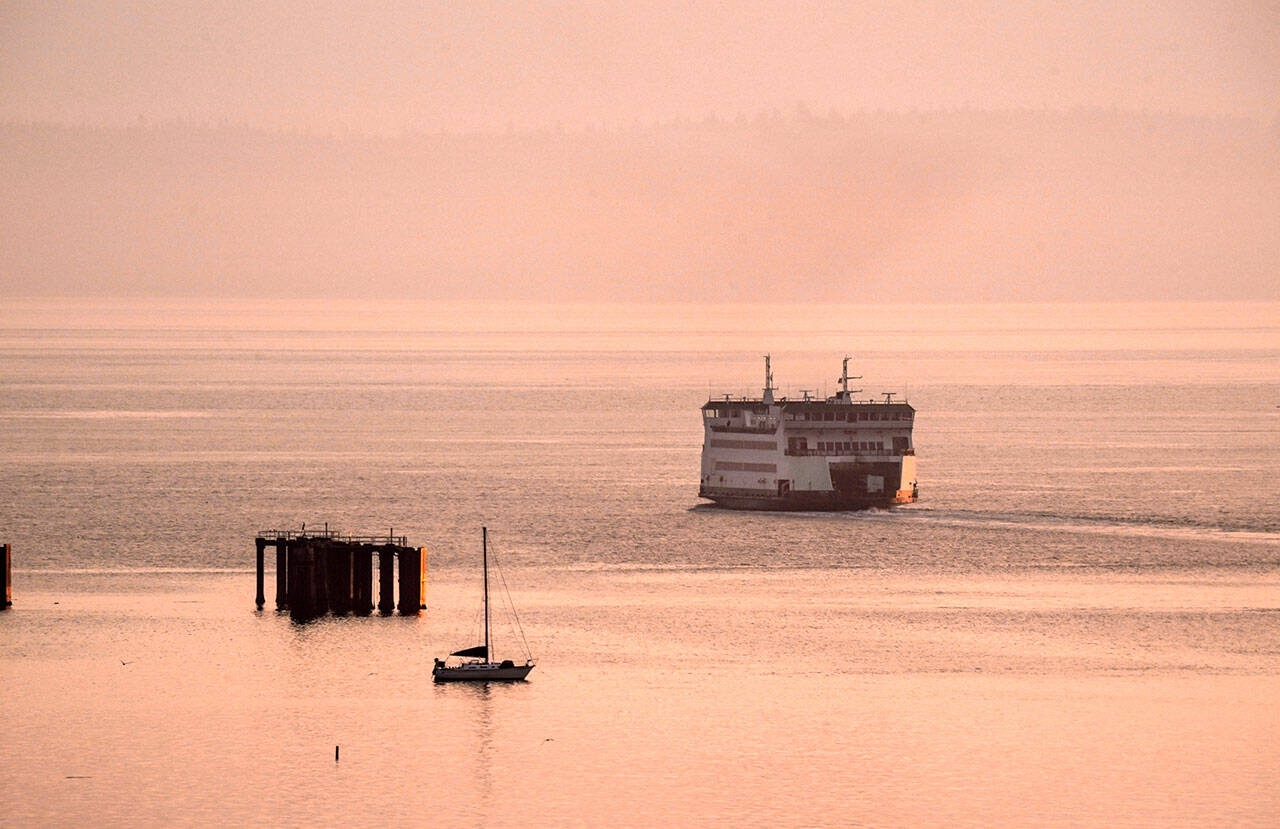 Smoke from the Cascade fires paints the sunrise in Port Townsend on Monday as the MV Salish heads for Whidbey Island on its 7:30 a.m. run. (Steve Mullensky/for Peninsula Daily News)