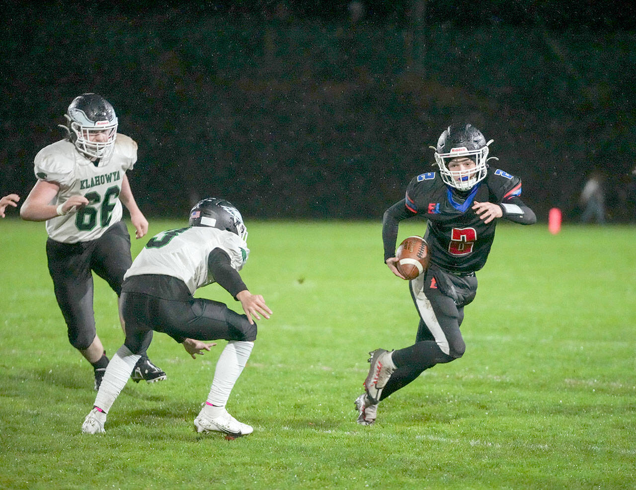 Steve Mullensky/for Peninsula Daily News East Jefferson’s Brody Moore dodges away from Klahowya players and picks up yardage during the Rivals’ 18-13 Senior Night win at Memorial Field on Friday in Port Townsend.