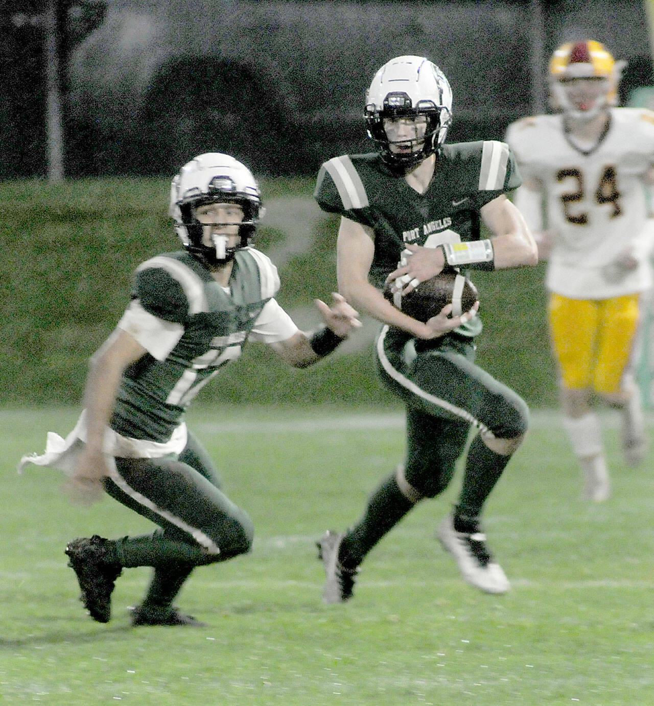 Port Angeles’ Blake Sohlberg, right, is followed by teammate Kason Albaugh, leaving Kingston’s Noah Walter far behind on Friday at Port Angeles Civic Field. (KEITH THORPE/PENINSULA DAILY NEWS)