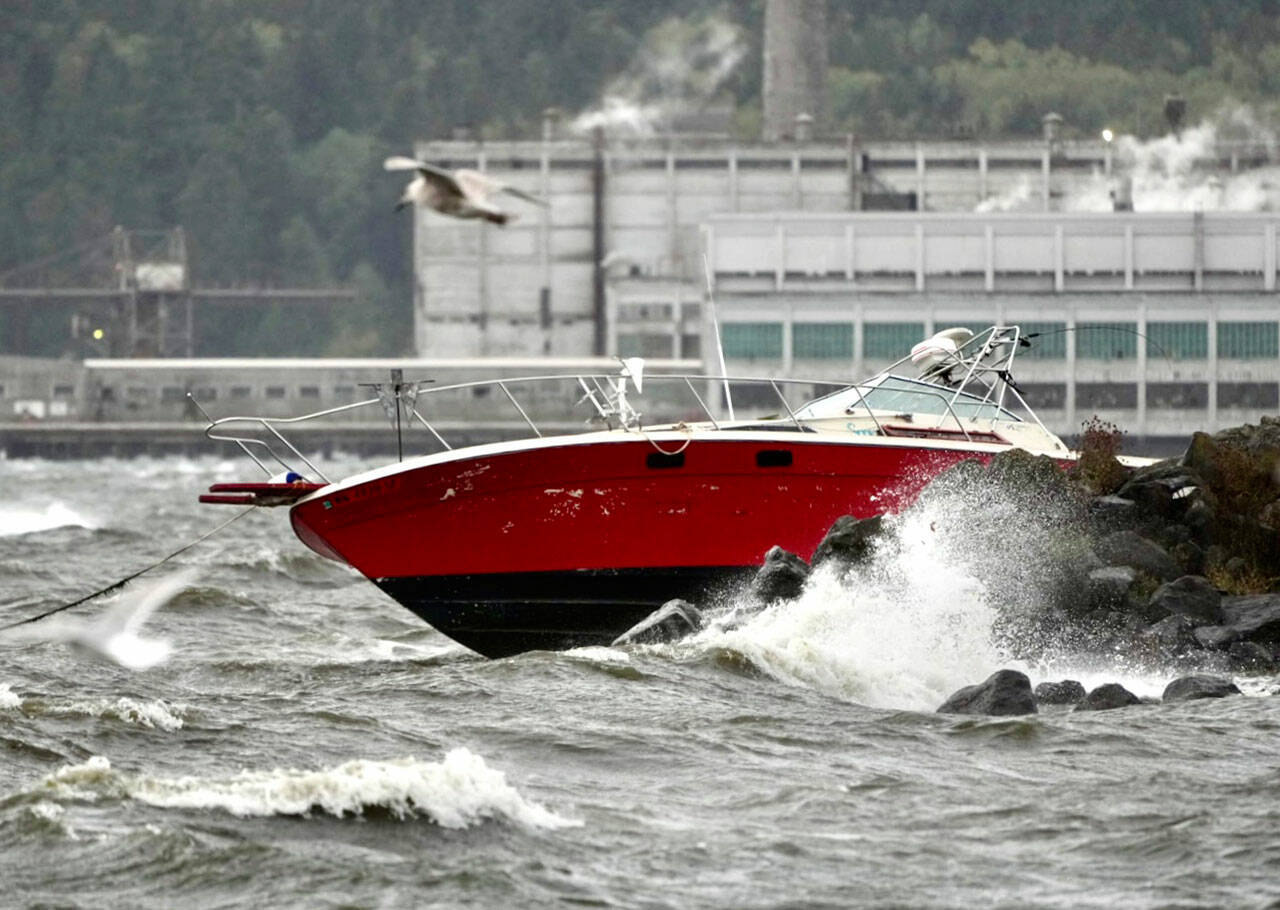 A power boat was driven onto rocks at Port Townsend Boat Haven after storm-driven winds whipped the bay into a frenzy of white caps about mid-day Tuesday. (Steve Mullensky/for Peninsula Daily News)