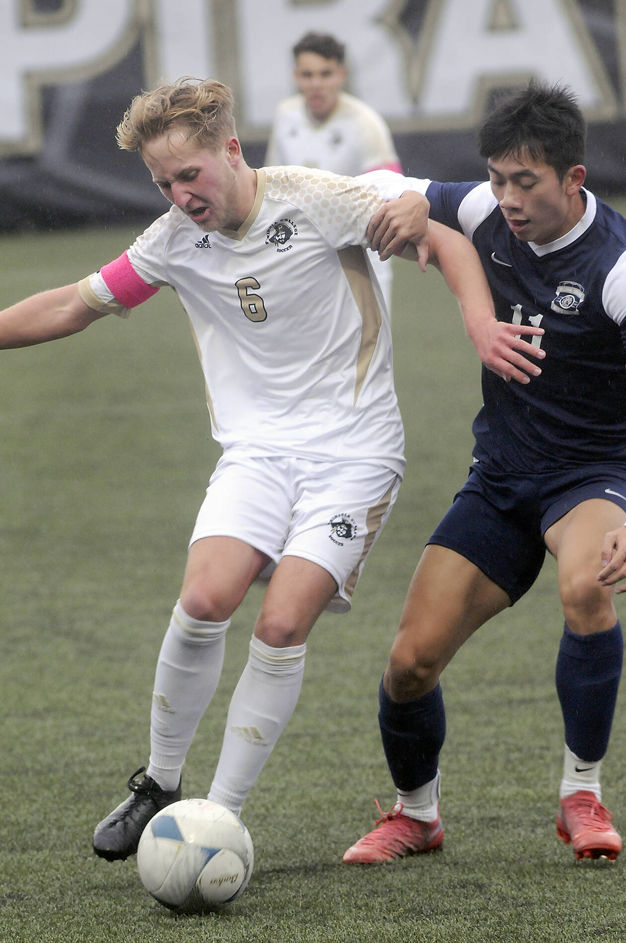 KEITH THORPE/PENINSULA DAILY NEWS
Peninsula's Tim Deser pushes back against Bellevue's Thomas Nguyen on Wednesday in Port Angeles.