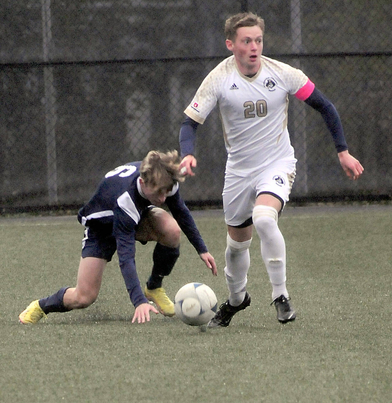 KEITH THORPE/PENINSULA DAILY NEWS
Peninsula's Gabriel Kiekenbeck, right, gets up with the ball after getting tangled with Bellevue's Sebastian Bednick during Wednesday's match in Port Angeles.