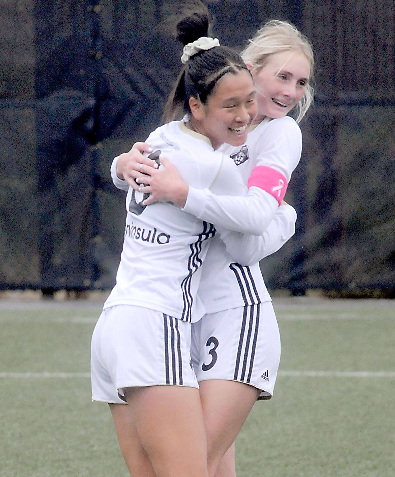 KEITH THORPE/PENINSULA DAILY NEWS Peninsula's Chiaki Takase (right) celebrates a goal with teammate Millie Long, who scored two goals earlier against Bellevue at Peninsula College on Wednesday.